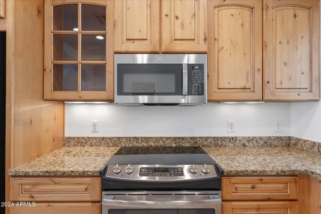 a stove top oven sitting inside of a kitchen