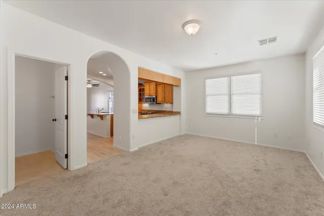 an empty room with windows and closet