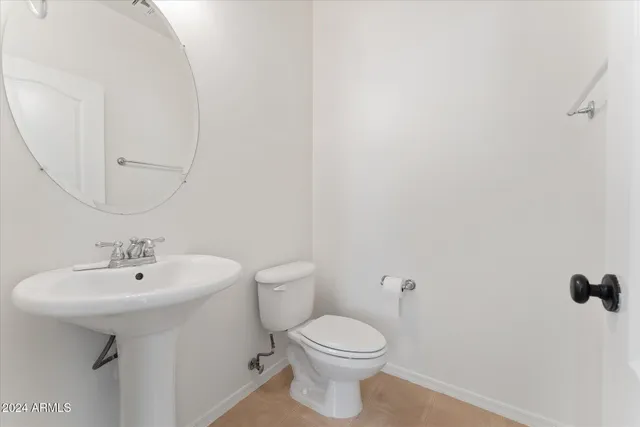a bathroom with a sink a toilet and mirror