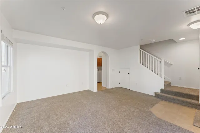 a view of an empty room with stairs