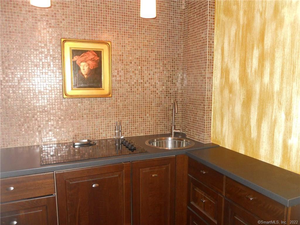 a bathroom with a granite countertop sink a mirror and a window