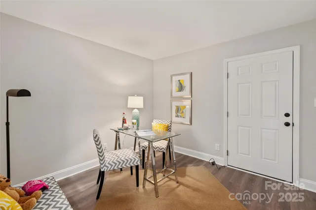 a dining room with furniture and wooden floor