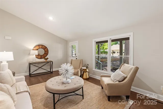 a living room with furniture a window and a potted plants