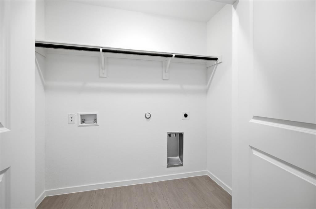 2128 Doc Holliday Road Joshua, TX 76058 - Photo 7 of 28 Dedicated utility space featuring a built-in hanging rod, light wood-finish flooring, and white baseboards