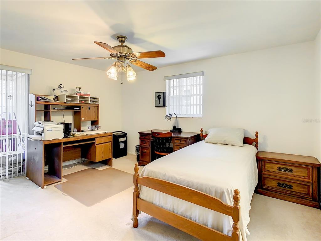 4230 Redcliff Place, Unit 4230 New Port Richey, FL 34652 - Photo 14 of 42 a bedroom with furniture and a chandelier