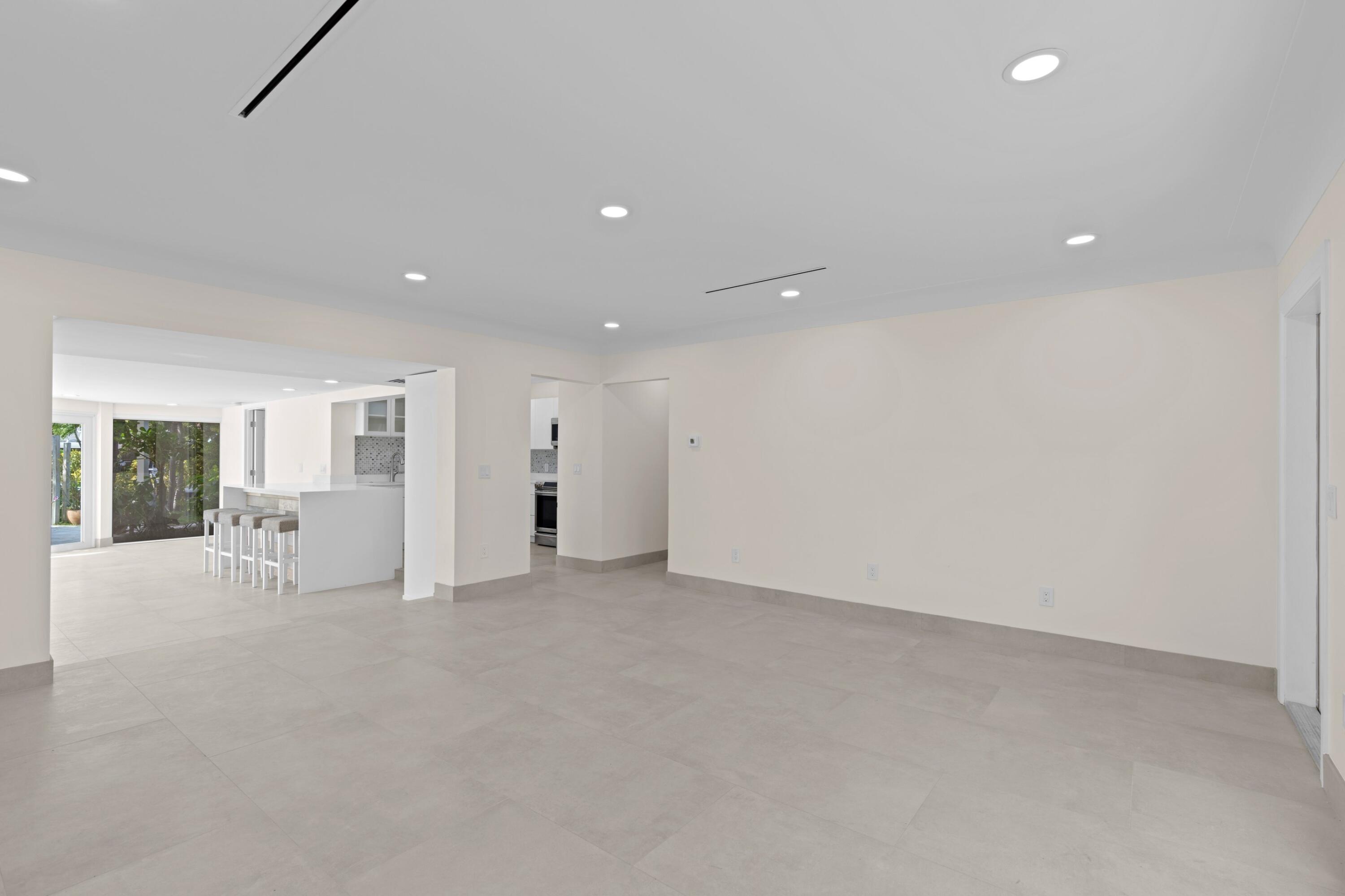 391 Southeast 7th Avenue Pompano Beach, FL 33060 - Photo 15 of 38 an empty room with fireplace and windows