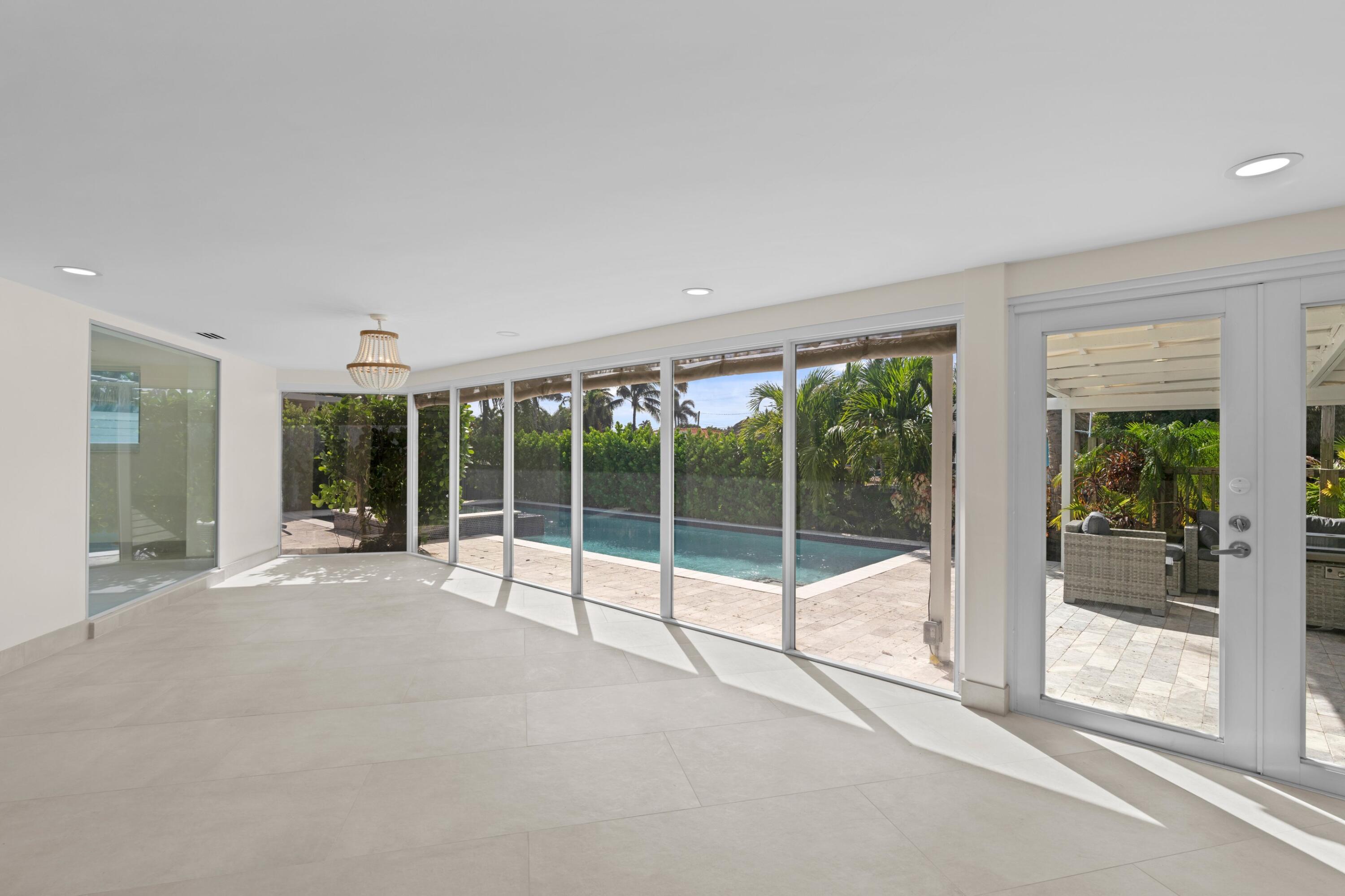 391 Southeast 7th Avenue Pompano Beach, FL 33060 - Photo 17 of 38 a view of an empty room with windows and a balcony