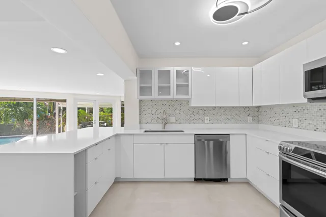 an empty room with wooden floor and garden view