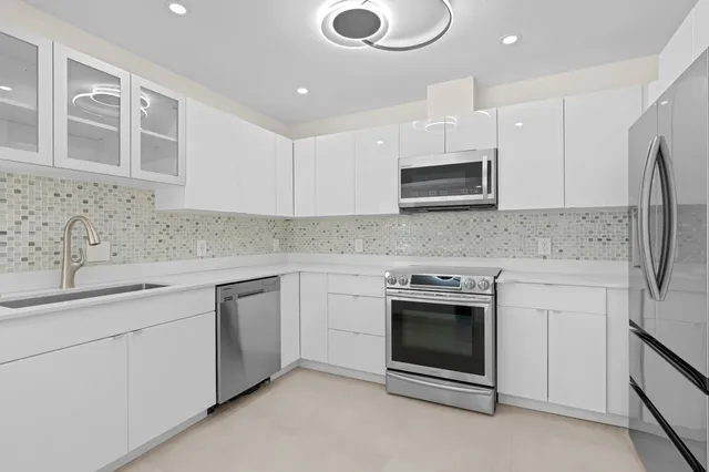 a view of a house with a yard and potted plants