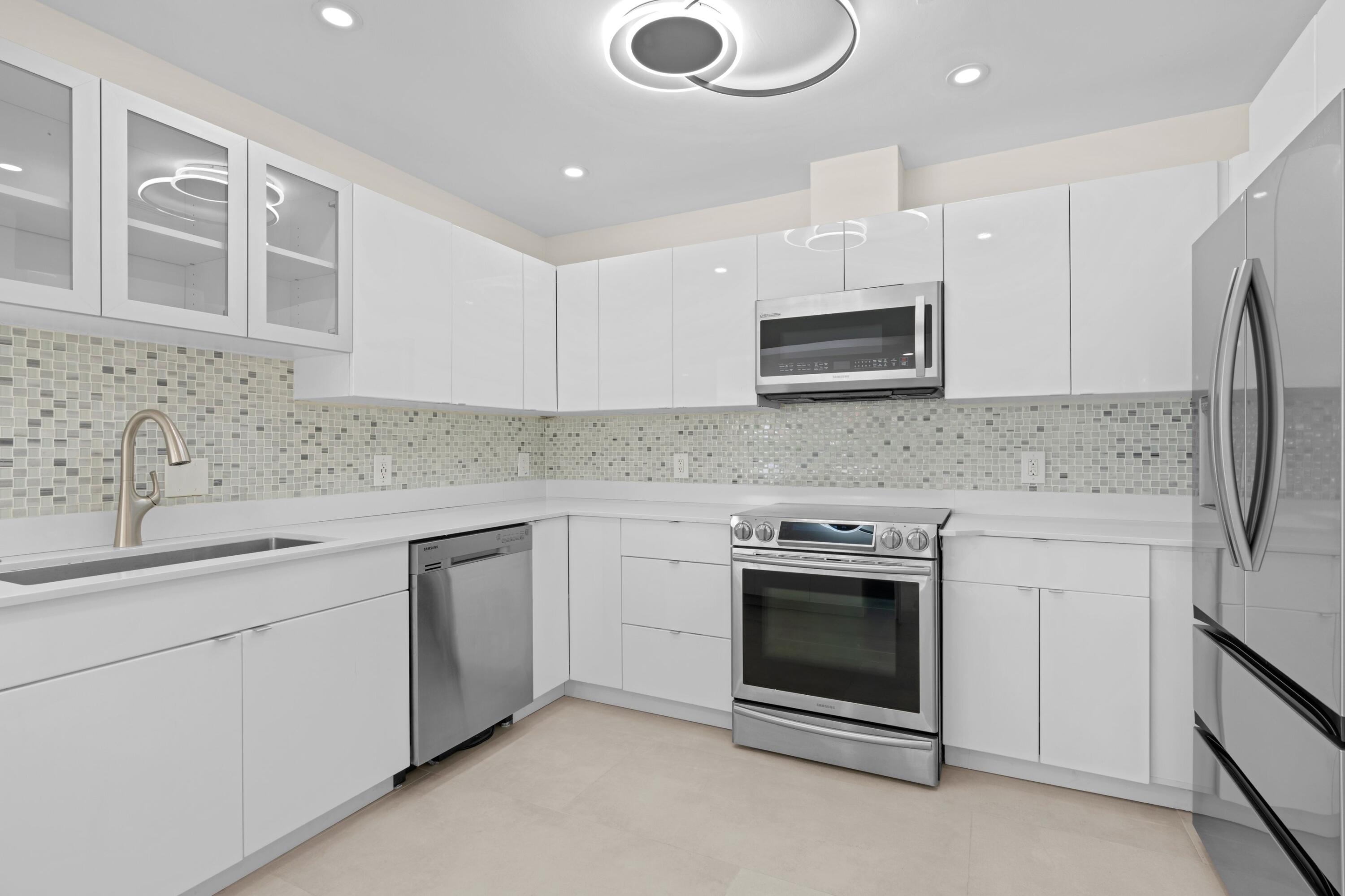 391 Southeast 7th Avenue Pompano Beach, FL 33060 - Photo 20 of 38 a kitchen with stainless steel appliances granite countertop a stove and a sink