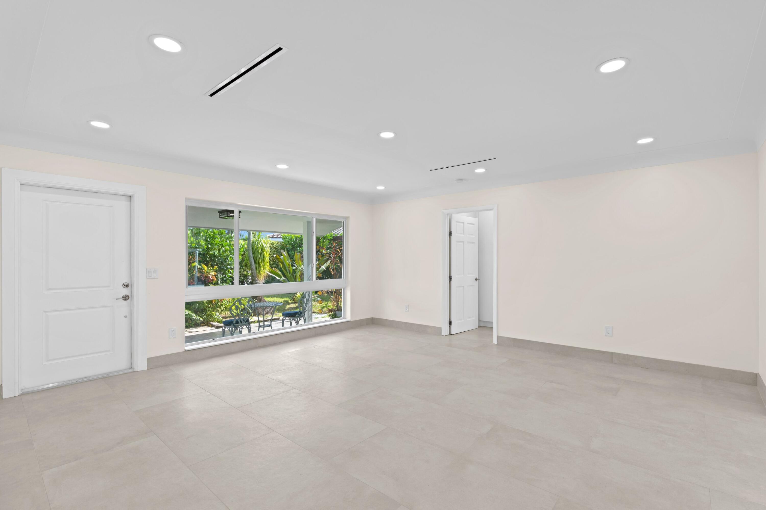 391 Southeast 7th Avenue Pompano Beach, FL 33060 - Photo 22 of 38 a view of an empty room with wooden floor and a window