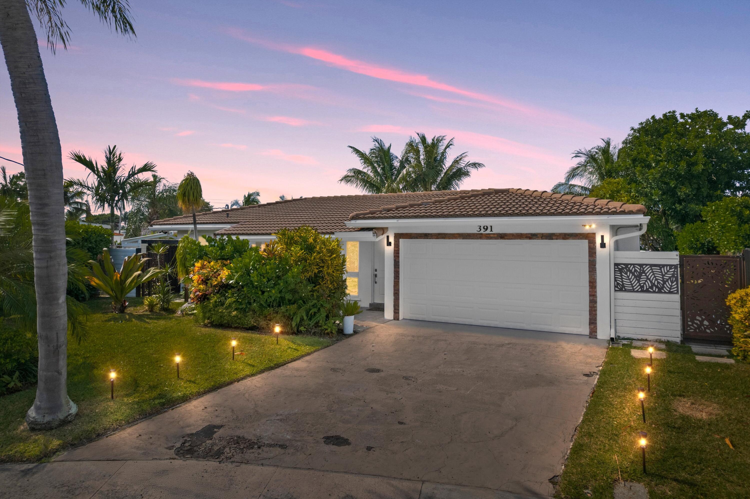 391 Southeast 7th Avenue Pompano Beach, FL 33060 - Photo 29 of 38 a view of a house with a yard and potted plants