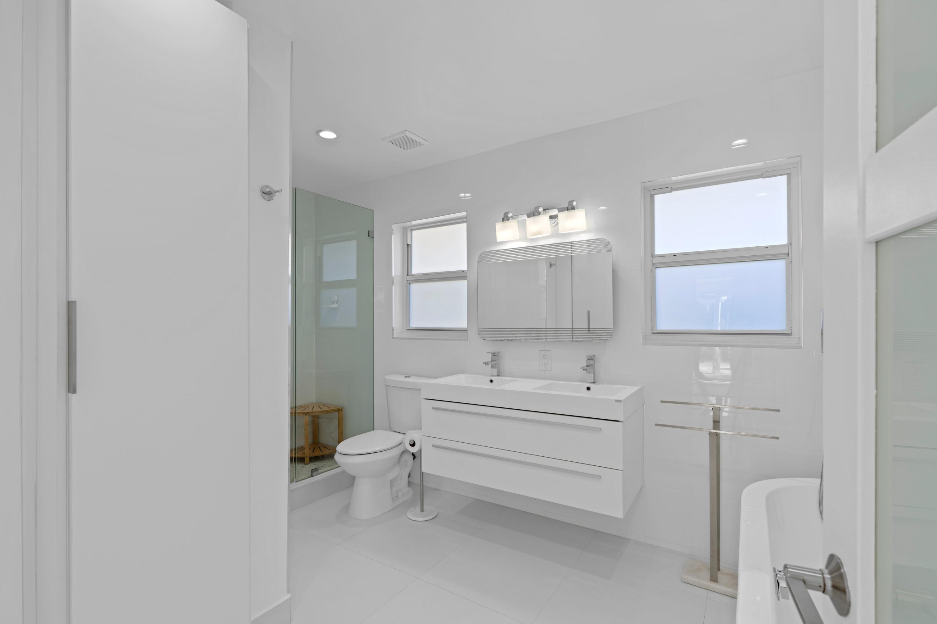 391 Southeast 7th Avenue Pompano Beach, FL 33060 - Photo 30 of 38 a bathroom with a sink toilet and mirror