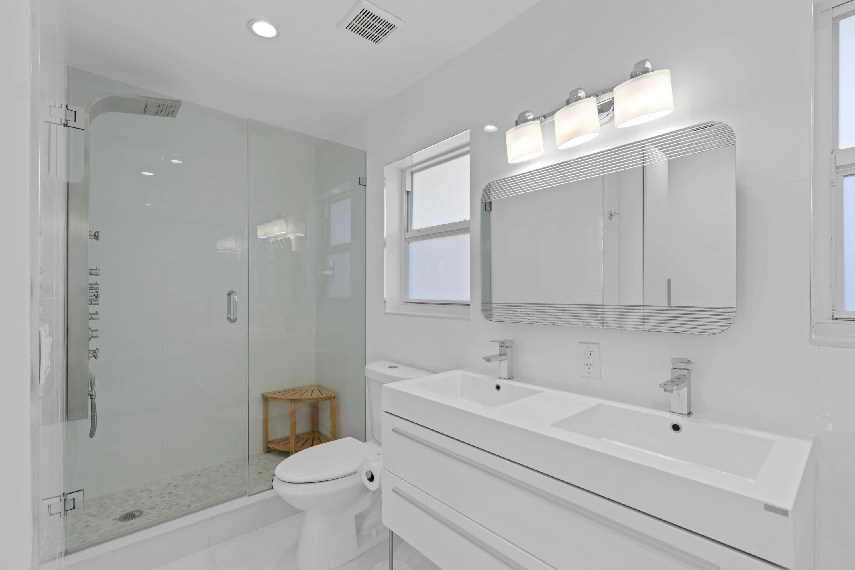 391 Southeast 7th Avenue Pompano Beach, FL 33060 - Photo 31 of 38 a bathroom with a sink a toilet and shower