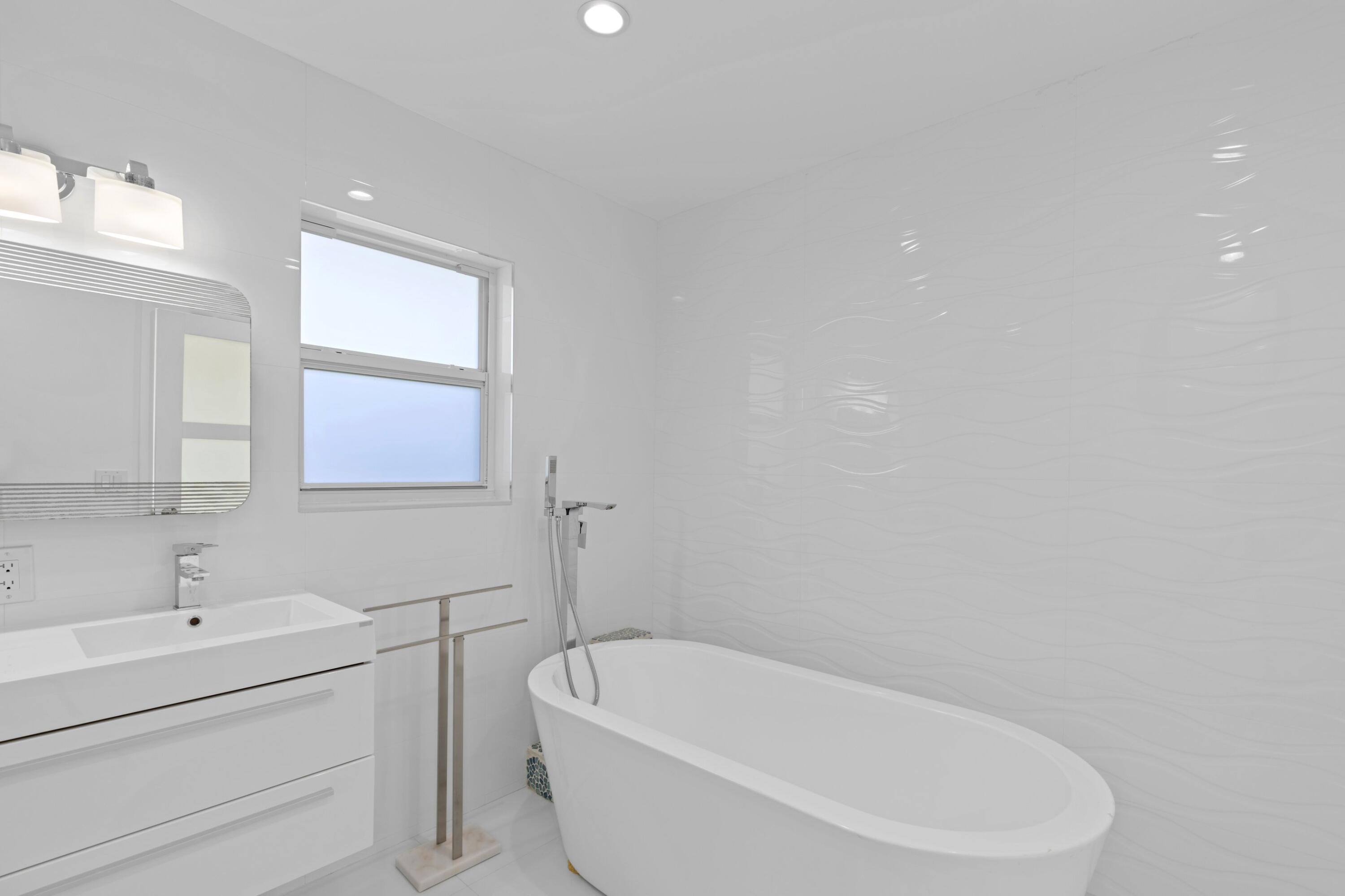 391 Southeast 7th Avenue Pompano Beach, FL 33060 - Photo 32 of 38 a white bath tub sitting next to a white sink