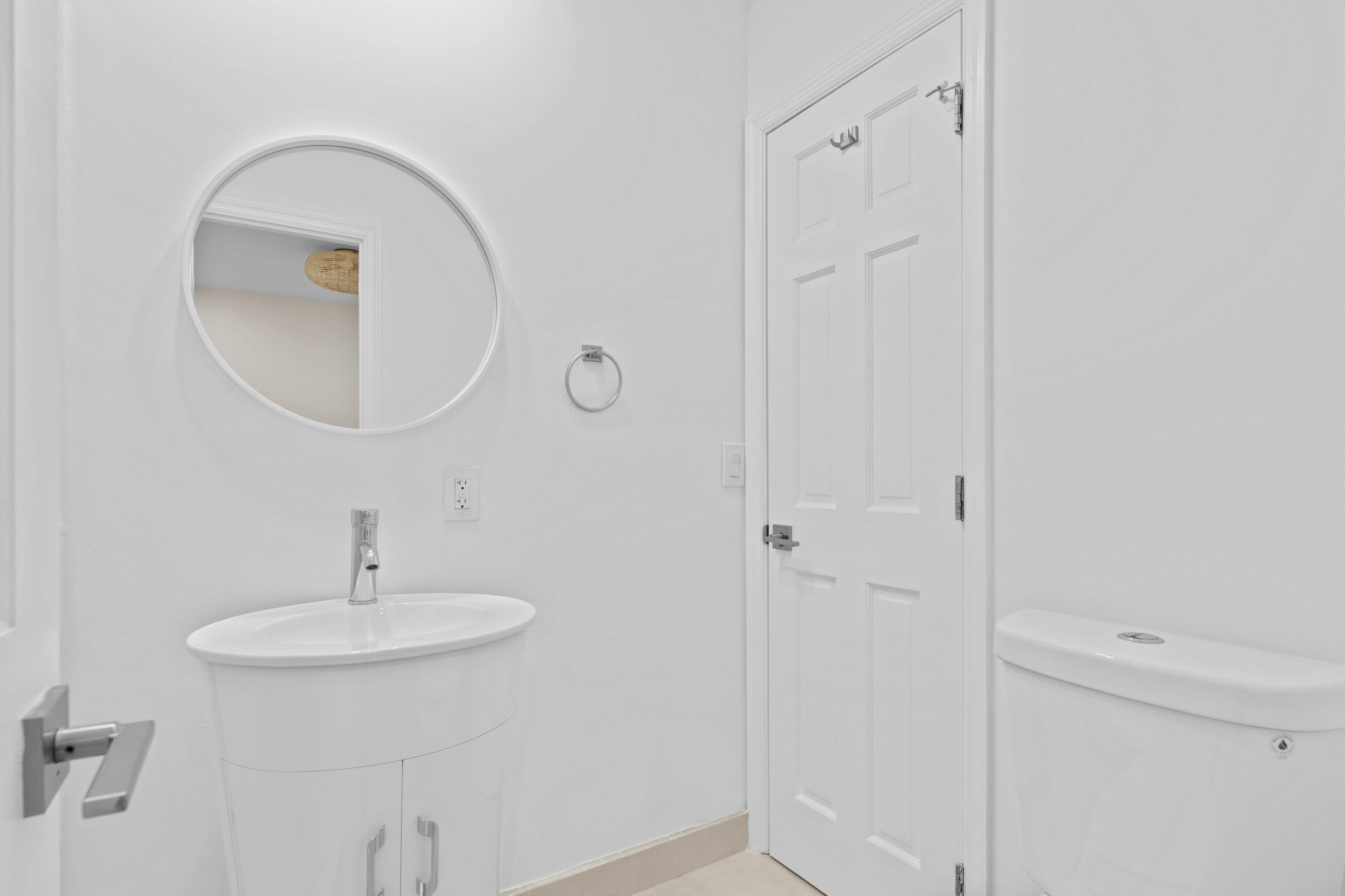 391 Southeast 7th Avenue Pompano Beach, FL 33060 - Photo 34 of 38 a bathroom with a sink and a mirror