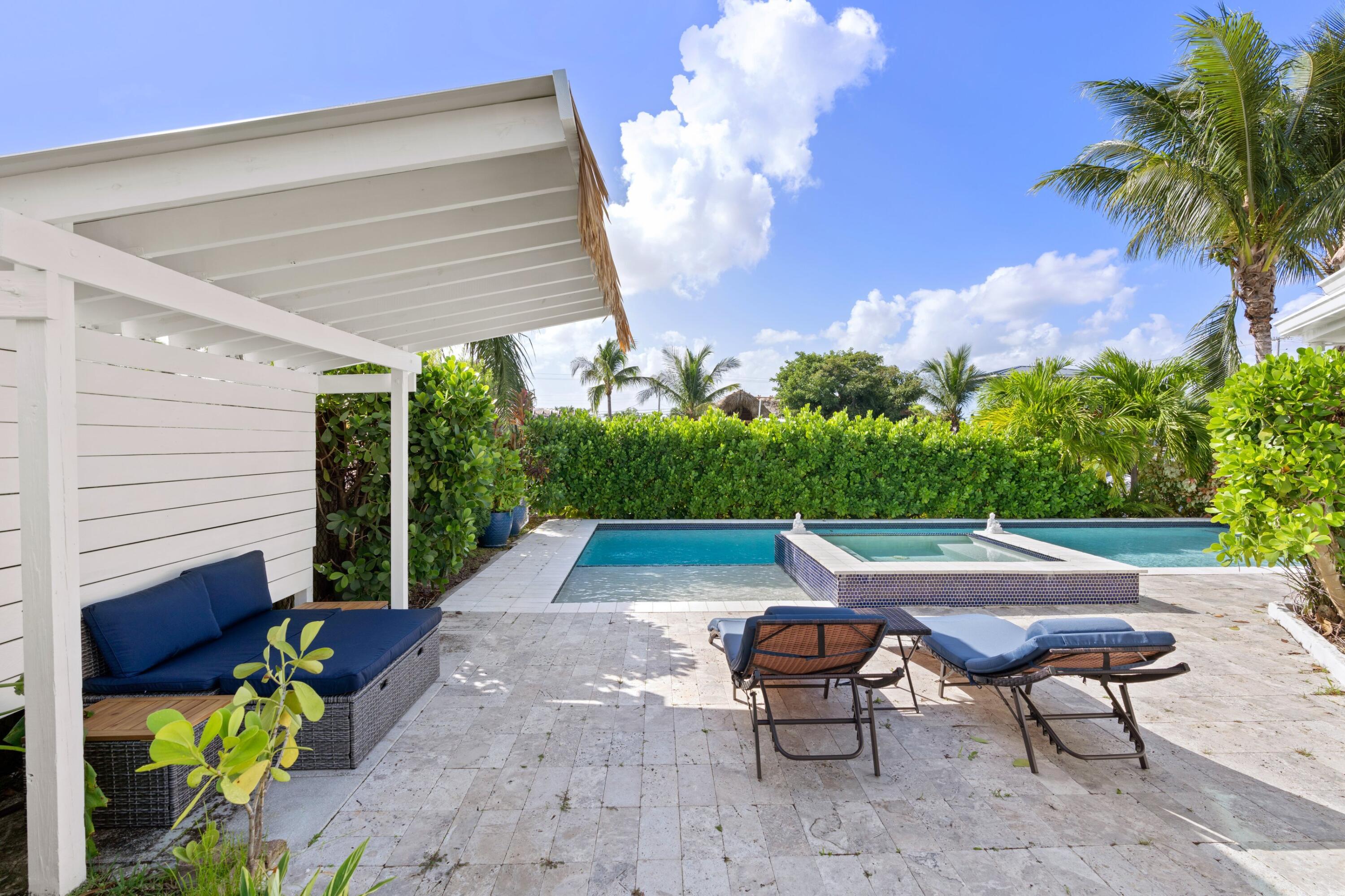 391 Southeast 7th Avenue Pompano Beach, FL 33060 - Photo 6 of 38 a backyard of a house with table and chairs