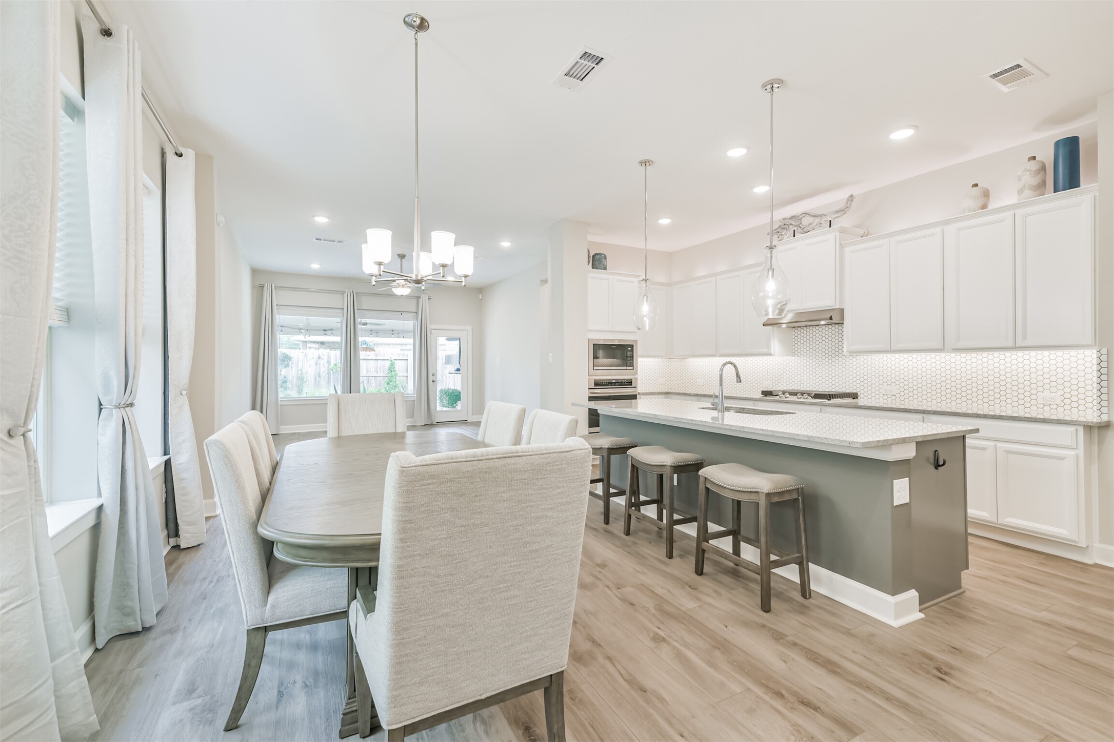 15611 Rising Wren Court Conroe, TX 77302 - Photo 11 of 38 a large kitchen with a table and chairs