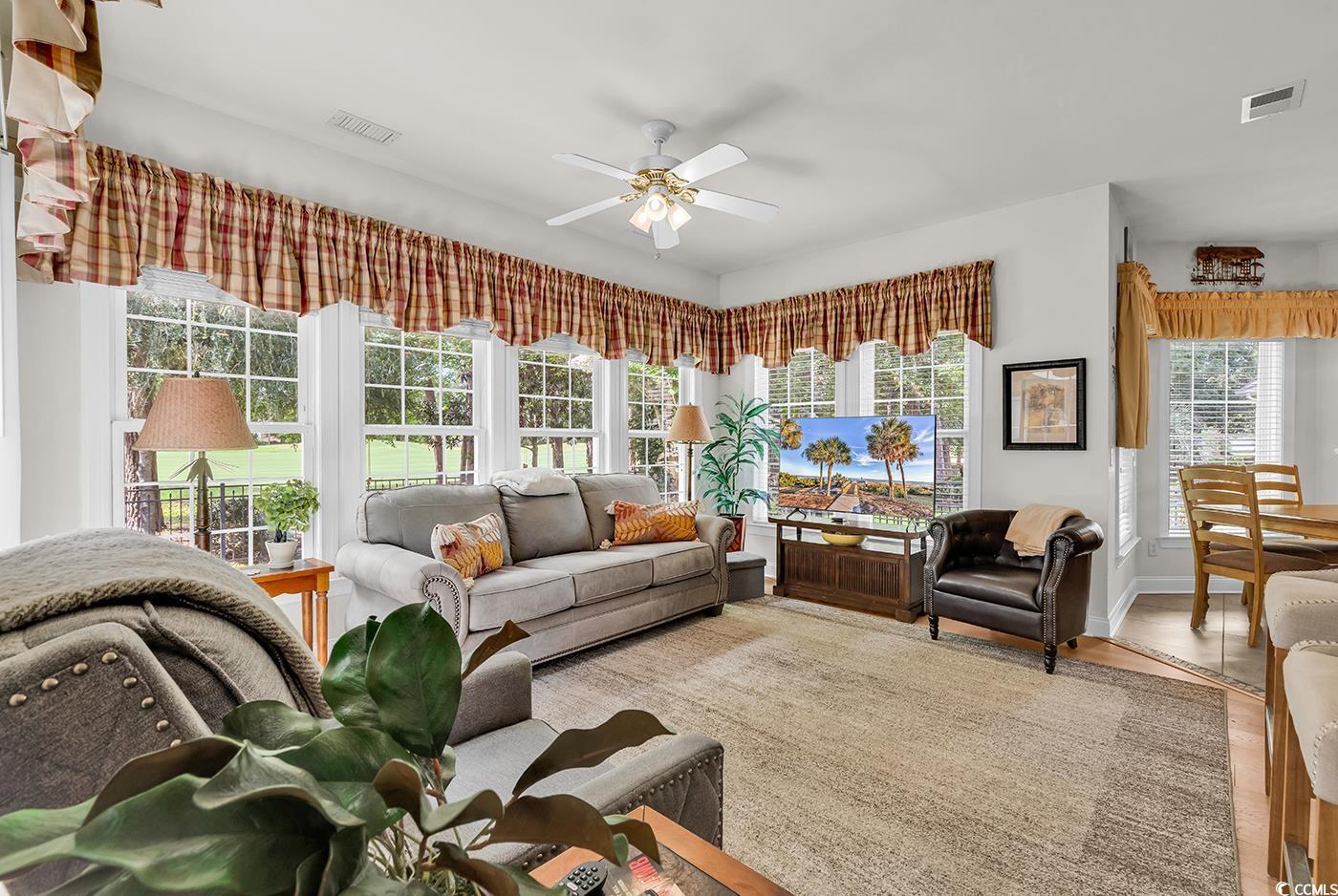 4507 Smilax Place Murrells Inlet, SC 29576 - Photo 11 of 39 Living area featuring a ceiling fan and wood finished floors