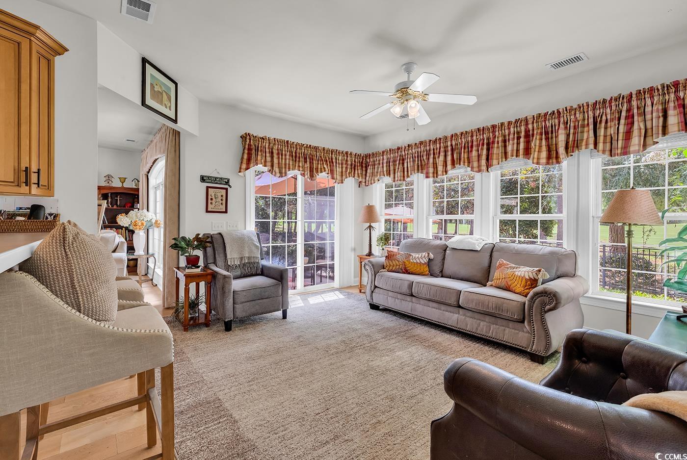 4507 Smilax Place Murrells Inlet, SC 29576 - Photo 13 of 39 Living area featuring healthy amount of natural light and ceiling fan