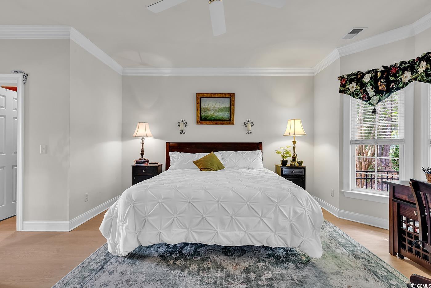 4507 Smilax Place Murrells Inlet, SC 29576 - Photo 17 of 39 Bedroom with light wood-style flooring, crown molding, and ceiling fan