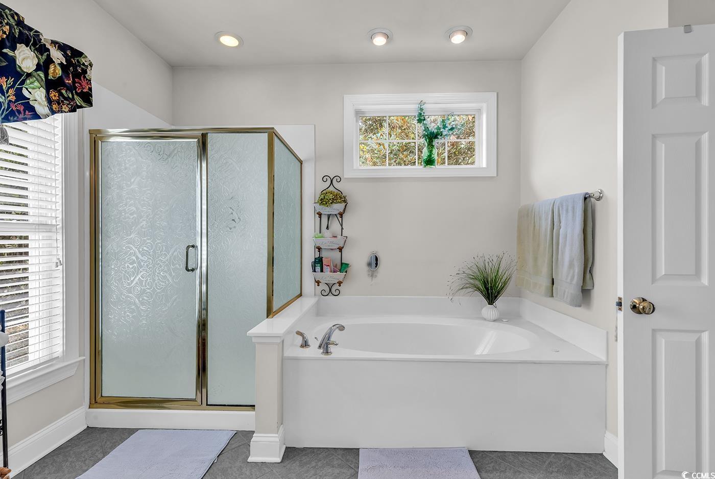 4507 Smilax Place Murrells Inlet, SC 29576 - Photo 20 of 39 Bathroom featuring a bath, a stall shower, and tile patterned floors