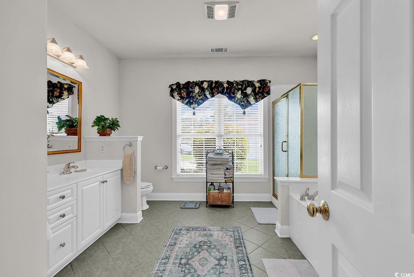 4507 Smilax Place Murrells Inlet, SC 29576 - Photo 21 of 39 Bathroom with vanity, a shower stall, tile patterned floors, and a bath