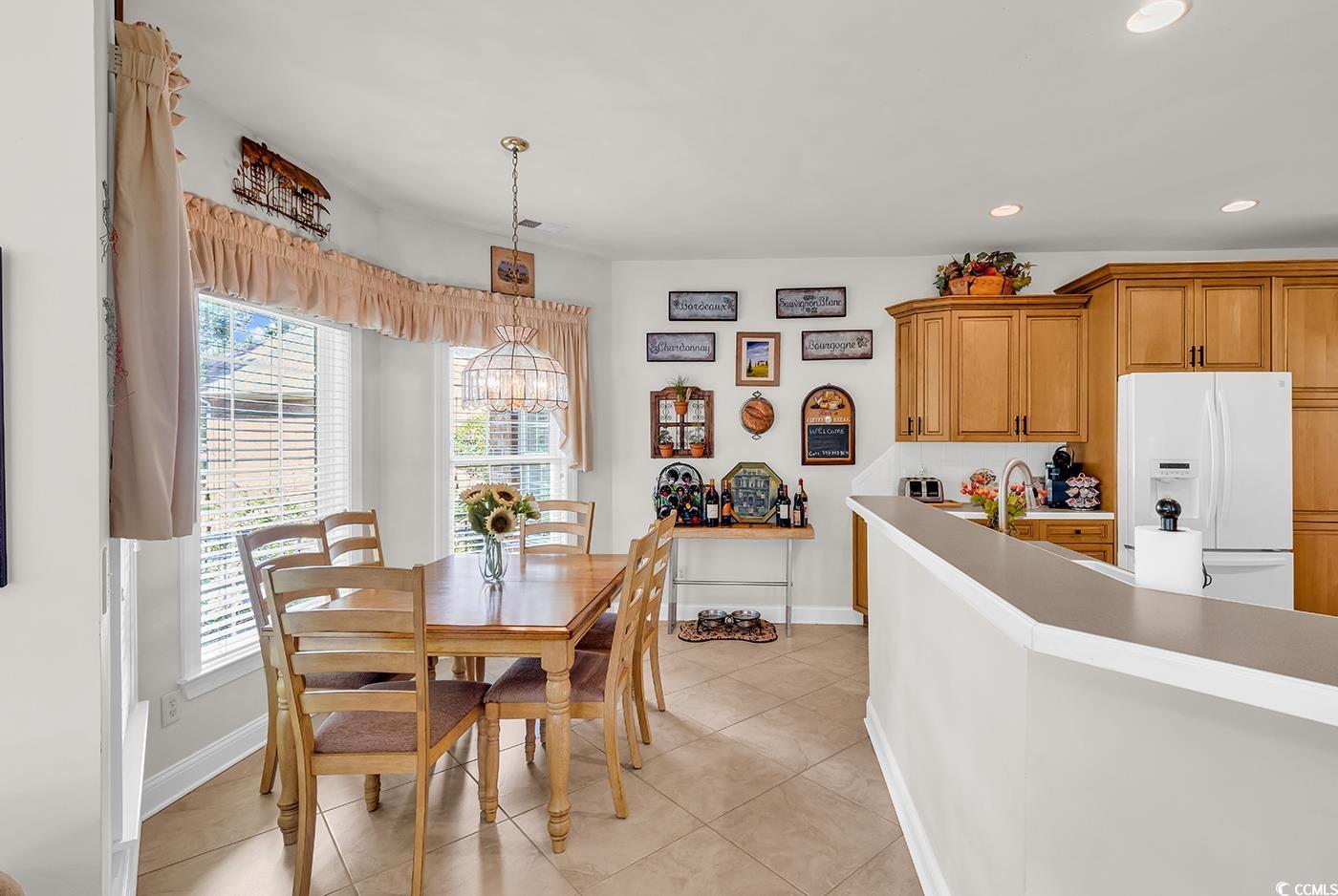 4507 Smilax Place Murrells Inlet, SC 29576 - Photo 7 of 39 Dining area featuring healthy amount of natural light, recessed lighting, light tile patterned floors, and a chandelier