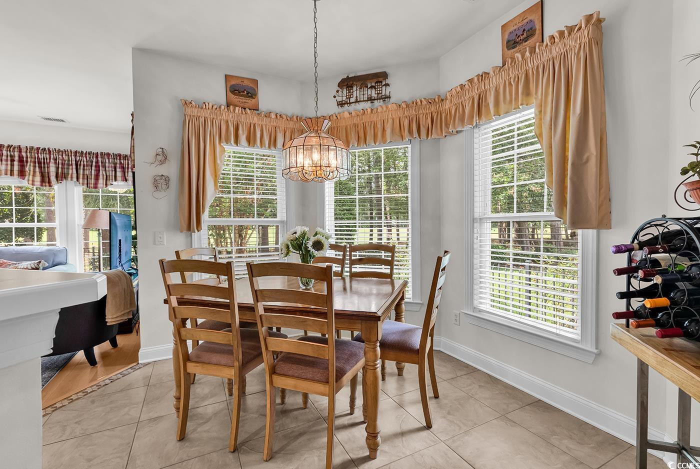 4507 Smilax Place Murrells Inlet, SC 29576 - Photo 8 of 39 Dining room with a chandelier and light tile patterned floors