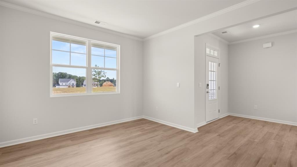 904 Sundown Point Villa Rica, GA 30180 - Photo 11 of 83 an empty room with wooden floor and windows
