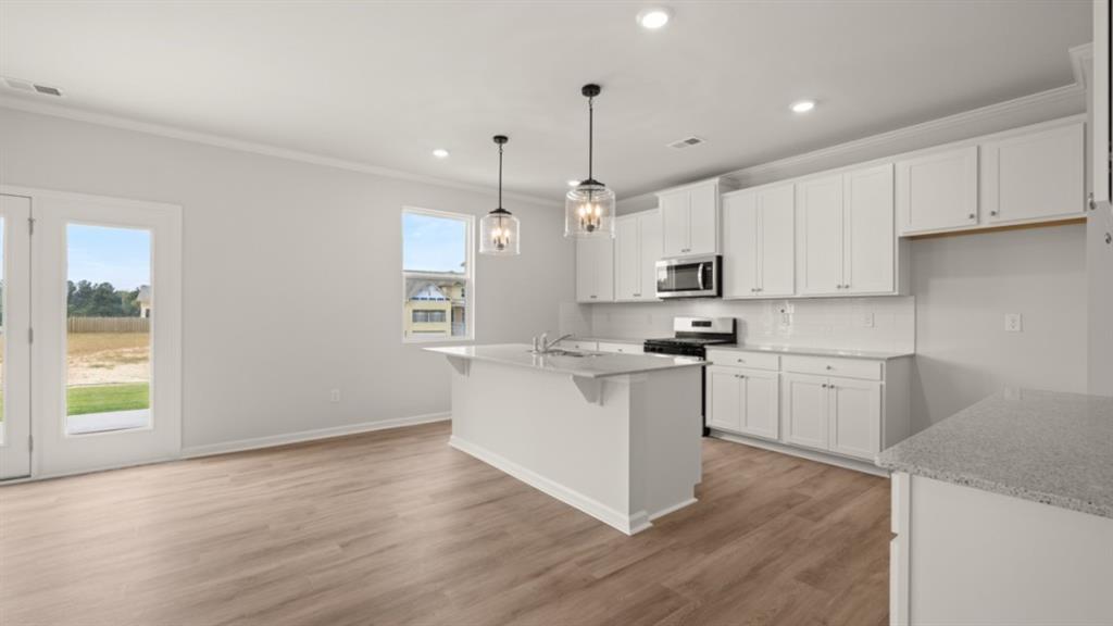 904 Sundown Point Villa Rica, GA 30180 - Photo 12 of 83 a kitchen with a refrigerator and white cabinets