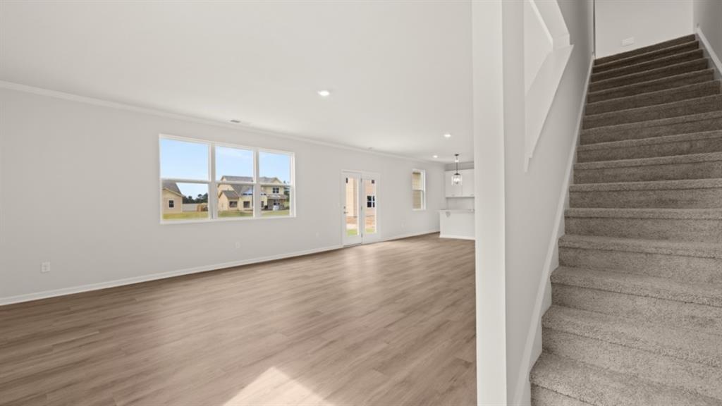 904 Sundown Point Villa Rica, GA 30180 - Photo 21 of 83 a view of an empty room with wooden floor and stairs