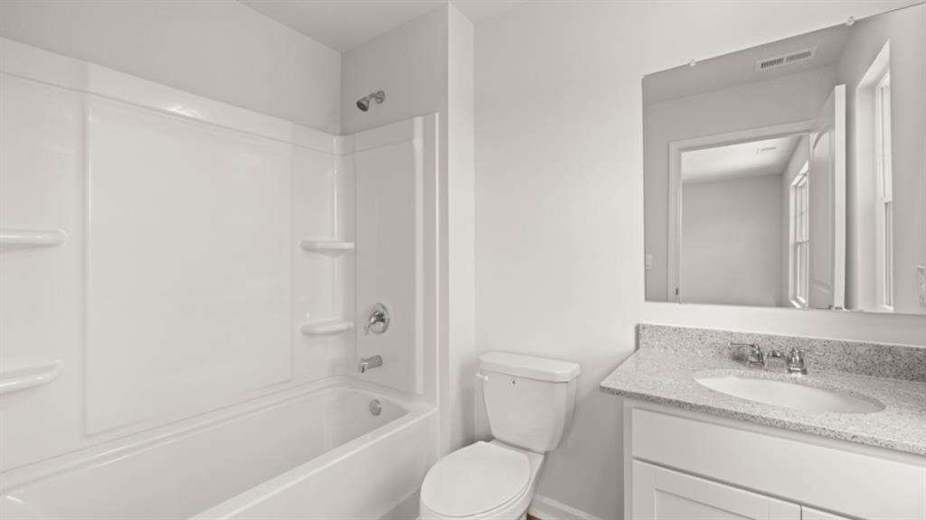 904 Sundown Point Villa Rica, GA 30180 - Photo 41 of 83 a bathroom with a granite countertop sink toilet and shower