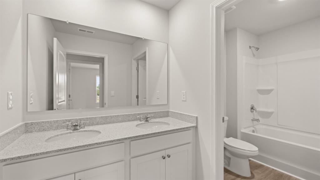 904 Sundown Point Villa Rica, GA 30180 - Photo 44 of 83 a bathroom with a granite countertop sink toilet and shower