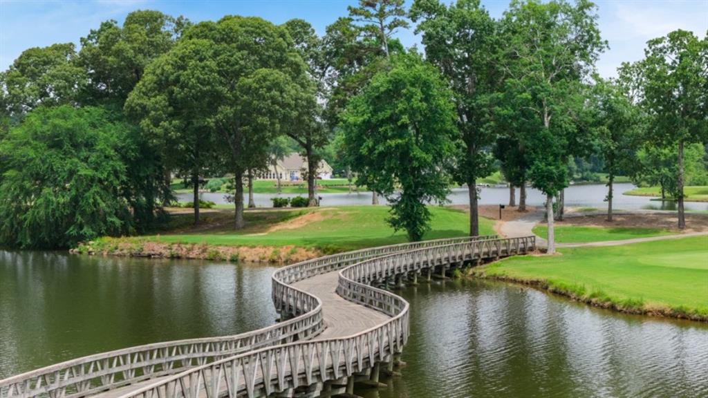 904 Sundown Point Villa Rica, GA 30180 - Photo 68 of 83 a view of a lake with a wooden deck and lake