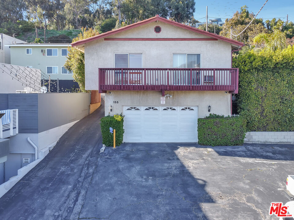 153 West Channel Road Santa Monica, CA 90402 - Photo 2 of 74 a front view of a house with a yard and garage