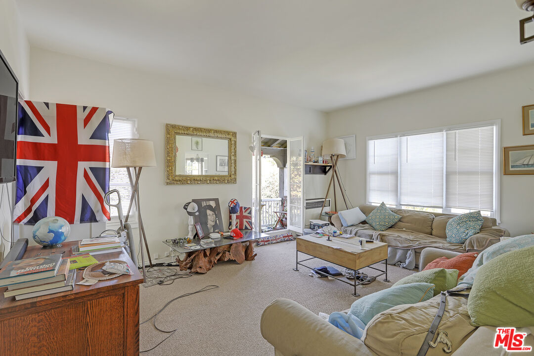 153 West Channel Road Santa Monica, CA 90402 - Photo 33 of 74 a living room with furniture and a flat screen tv