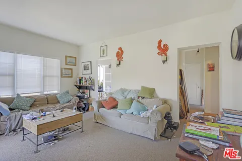 a front view of a house with a garden and deck