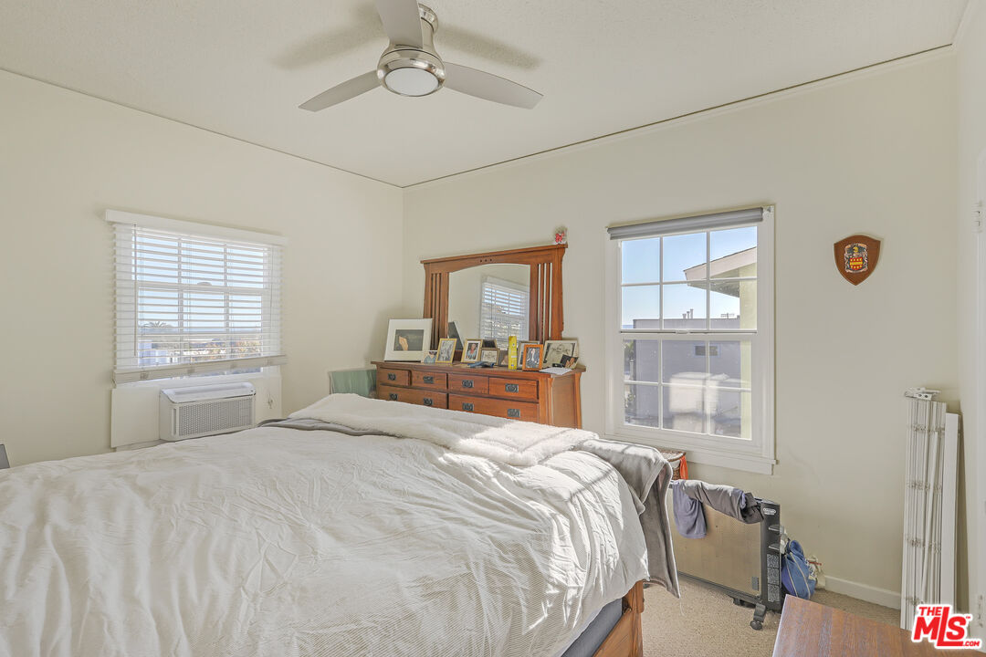 153 West Channel Road Santa Monica, CA 90402 - Photo 49 of 74 a bedroom with a large bed and a window