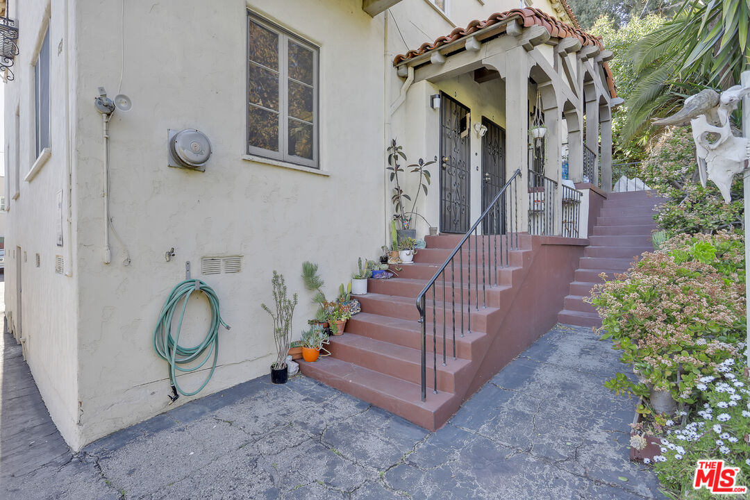 153 West Channel Road Santa Monica, CA 90402 - Photo 54 of 74 a view of a house with a yard and potted plants