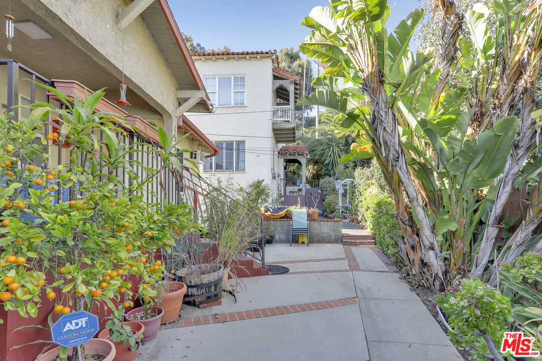 153 West Channel Road Santa Monica, CA 90402 - Photo 58 of 74 a view of a patio with couches and table and chairs and potted plants