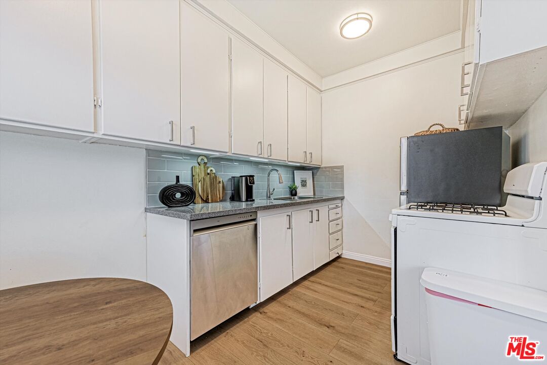 153 West Channel Road Santa Monica, CA 90402 - Photo 6 of 74 a kitchen with a refrigerator and white cabinets