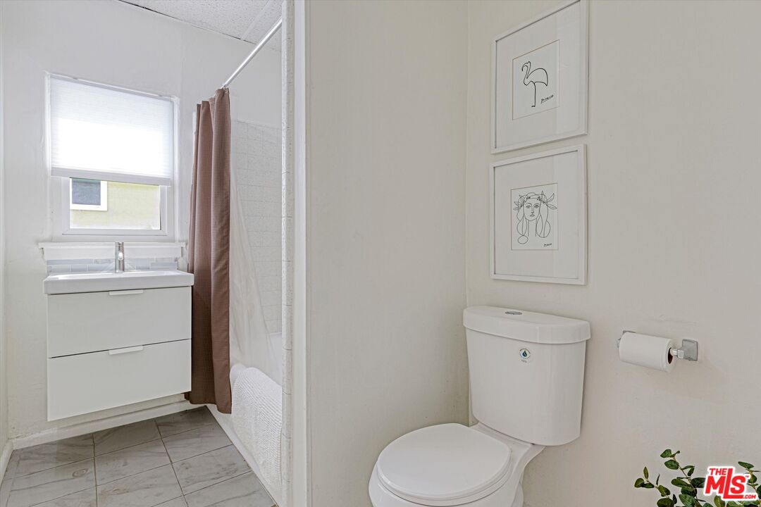 153 West Channel Road Santa Monica, CA 90402 - Photo 72 of 74 a white toilet sitting next to a bathroom sink