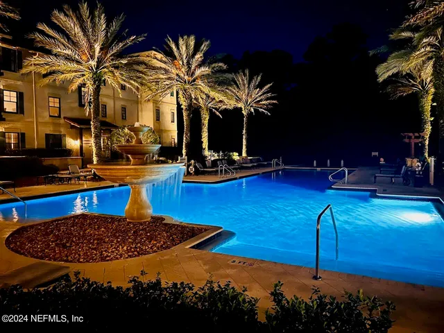 a view of a swimming pool with a table and chairs