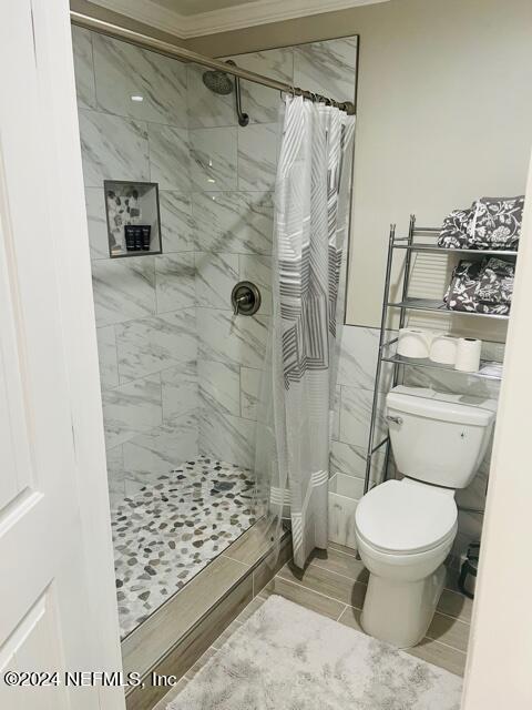 955 Registry Boulevard, Unit 210 St. Augustine, FL 32092 - Photo 20 of 31 a bathroom with a toilet and a shower