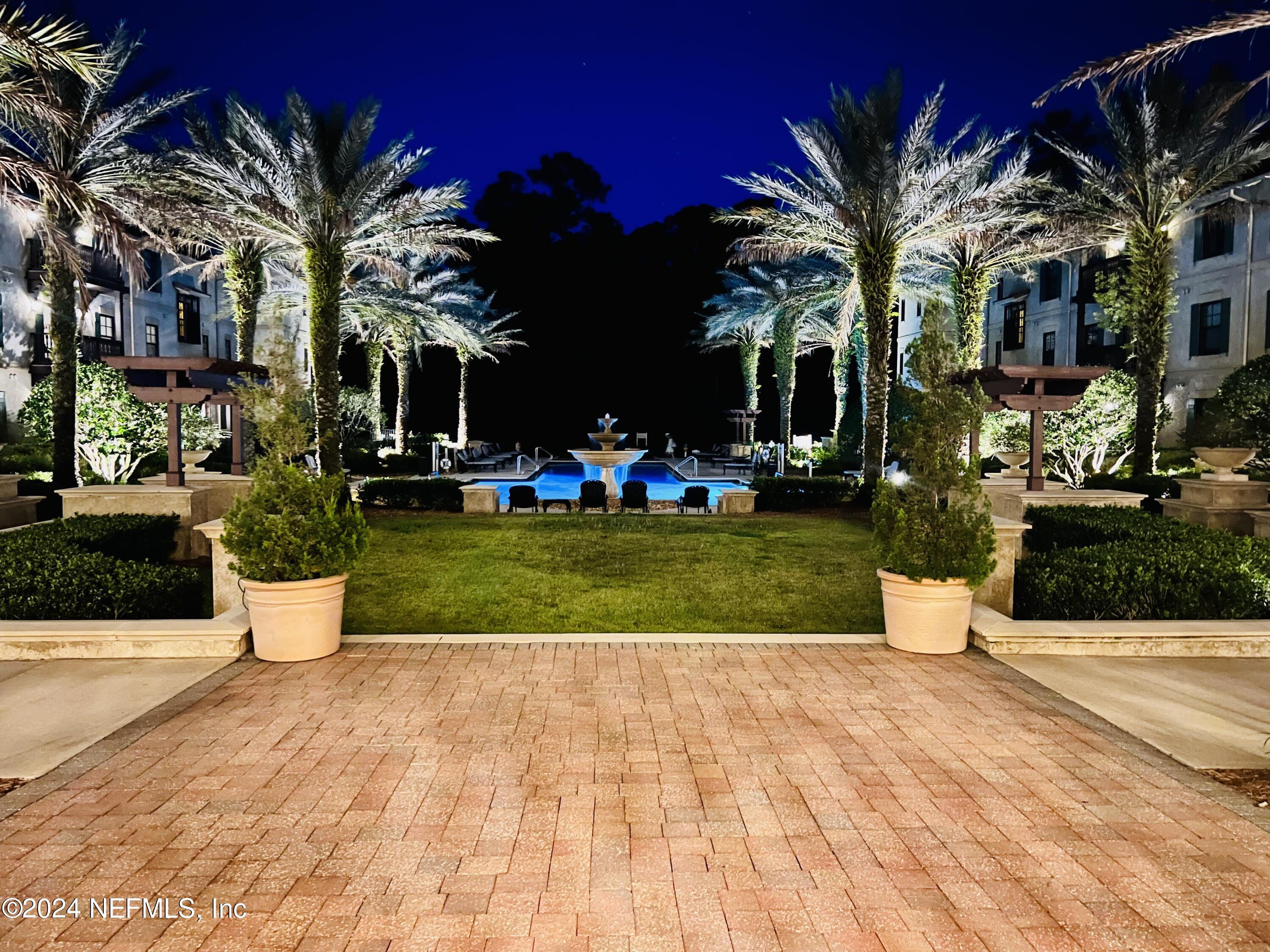 955 Registry Boulevard, Unit 210 St. Augustine, FL 32092 - Photo 2 of 31 a view of a white house with a yard and potted plants