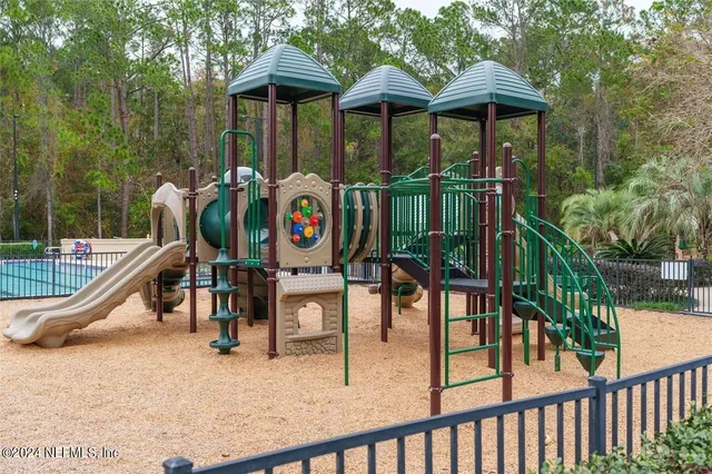 a lawn chairs sitting in a yard with large trees