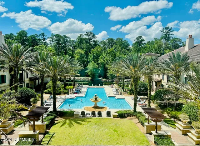 a view of a swimming pool with a yard