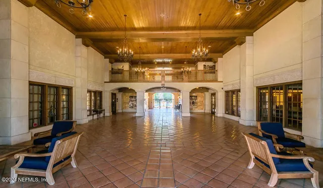 a view of a hall with dining area and chandelier