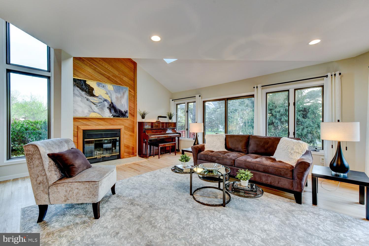 15 Hawk Drive Princeton Junction, NJ 08550 - Photo 20 of 95 a living room with furniture a fireplace and a floor to ceiling window